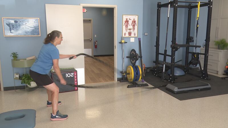Cindy Fuhr works out with battle ropes at Lasting Health and Wellness in Waco.