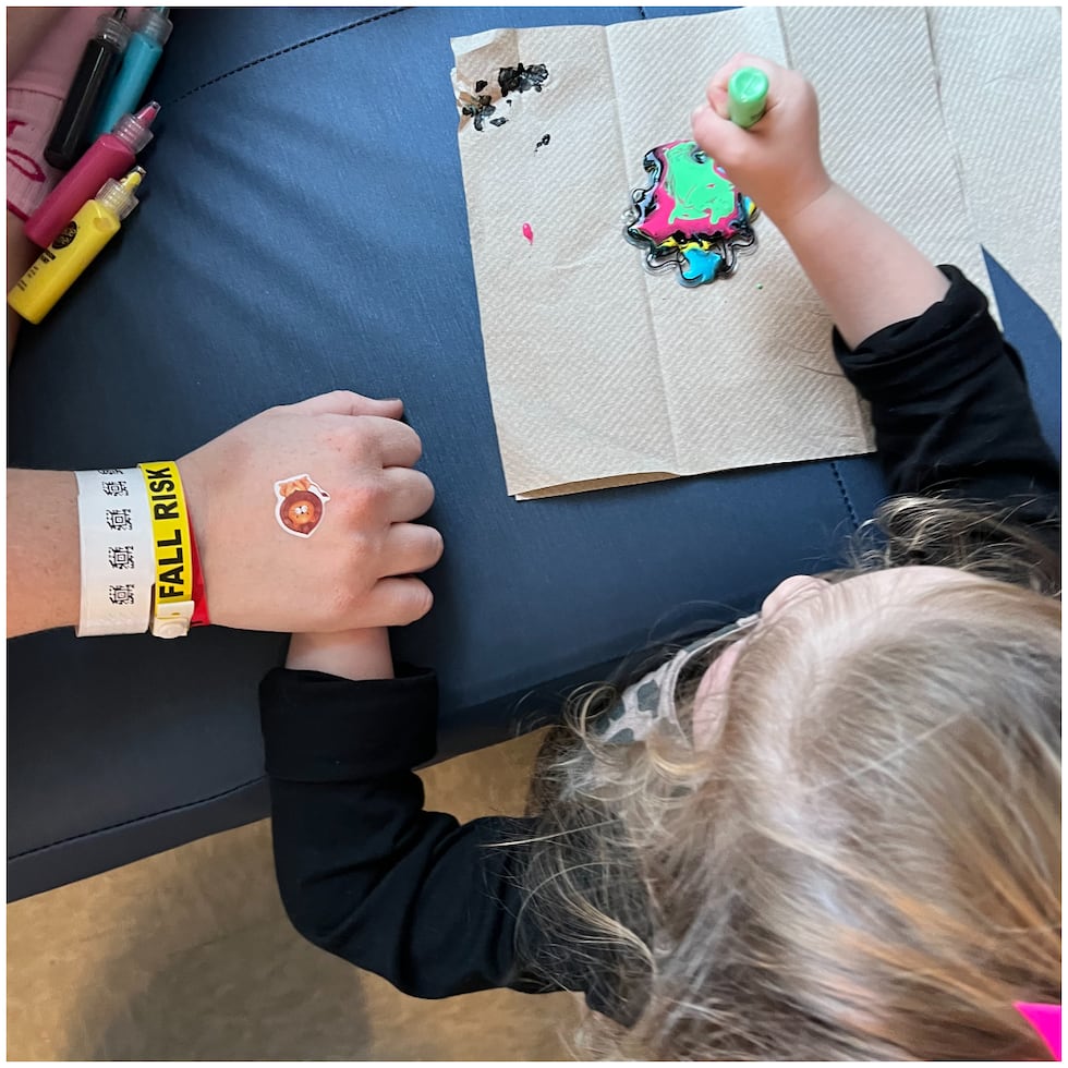 Katie Russell holds her daughter's hand