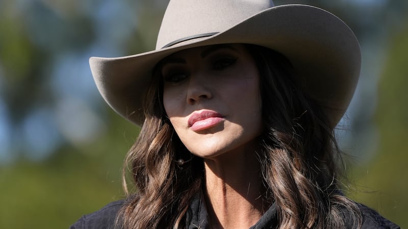 U.S. Homeland Security Secretary Kristi Noem sits on a horse as she speaks to the press upon...