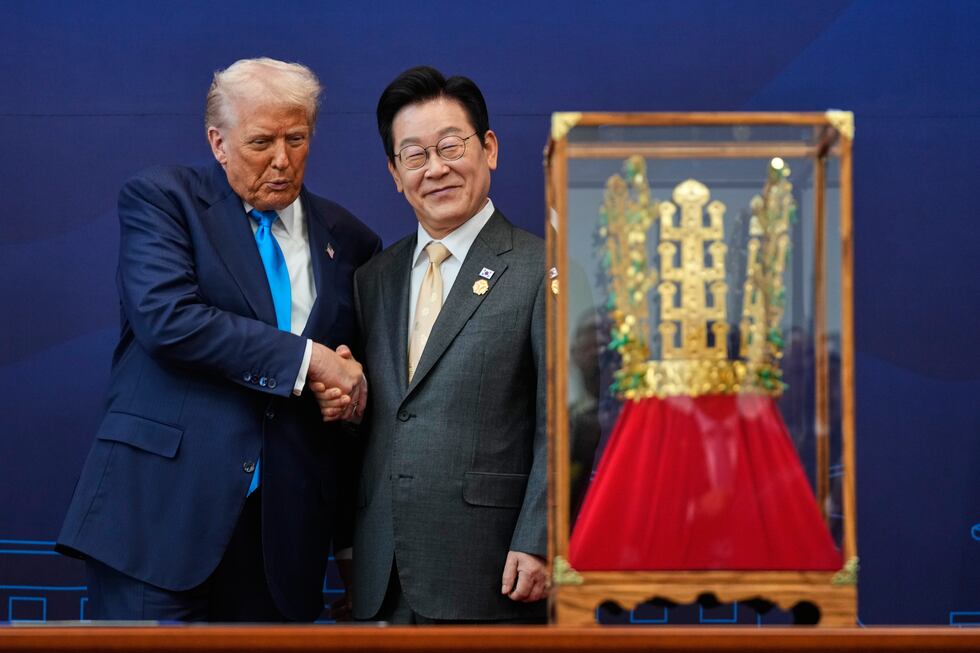 President Donald Trump shakes hands with South Korean President Lee Jae Myung as he receives a...