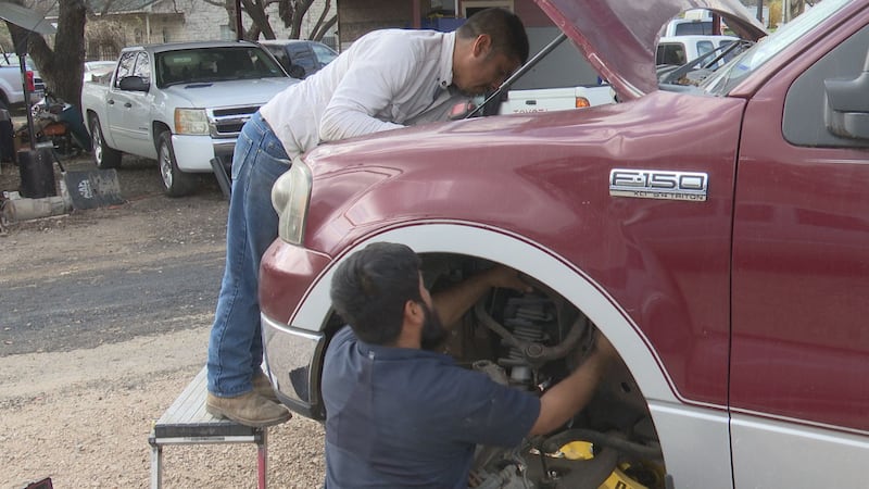 Freddy and Miguel Hernandez work on a vehicle for their business F&G Automotive