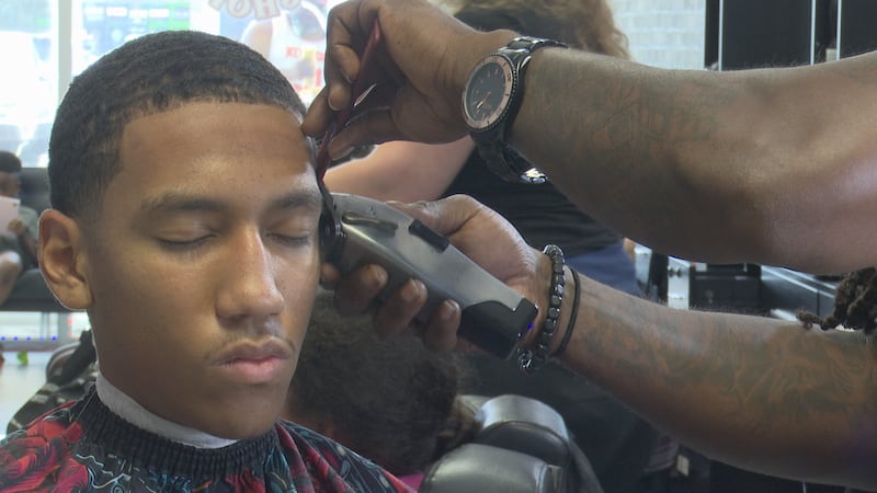 Youth receives free haircut for Inspired Designs' bac-to-school bash