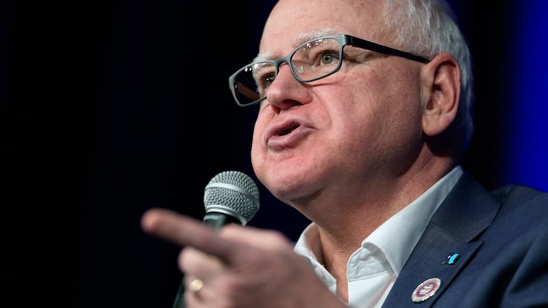 FILE - Minnesota Gov. Tim Walz speaks at a town hall event at Roosevelt High School, Friday,...
