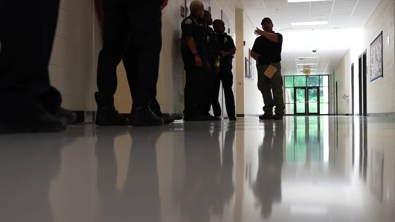 Officers stand in a hallway during an active shooter drill.