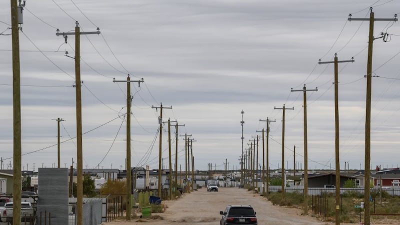 Motorists drive down a caliche road in Knox Village, a neighborhood in West Odessa, on Nov. 6,...