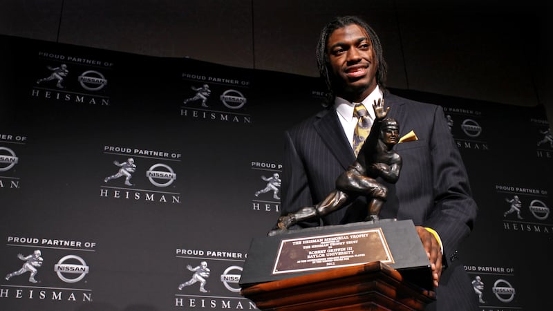 Heisman Trophy winner Robert Griffin III, of Baylor, is photographed with the award during a...