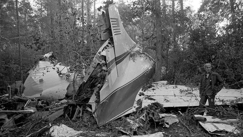 FILE - This Oct. 20, 1977 file photo shows the wreckage of a plane in a wooded area near...