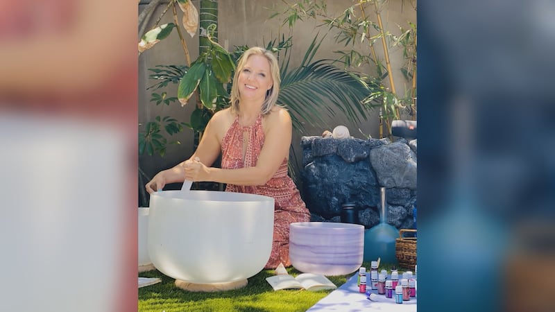 Near death experience survivor Ellen Wier practices music therapy for clients.