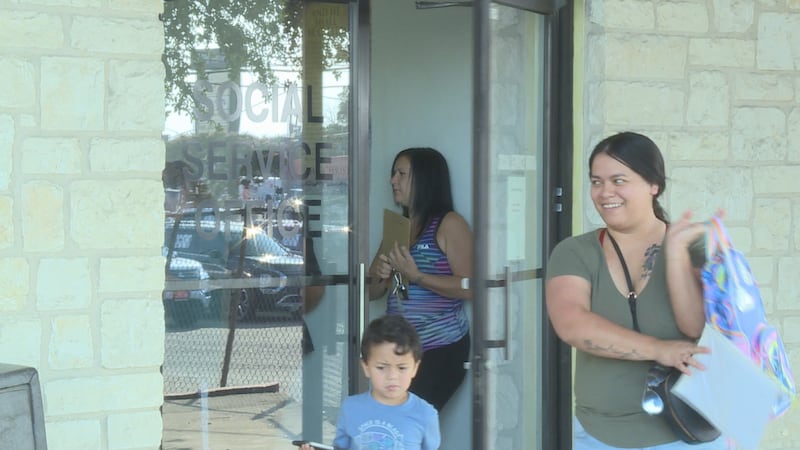 Families receive bags filled with school supplies